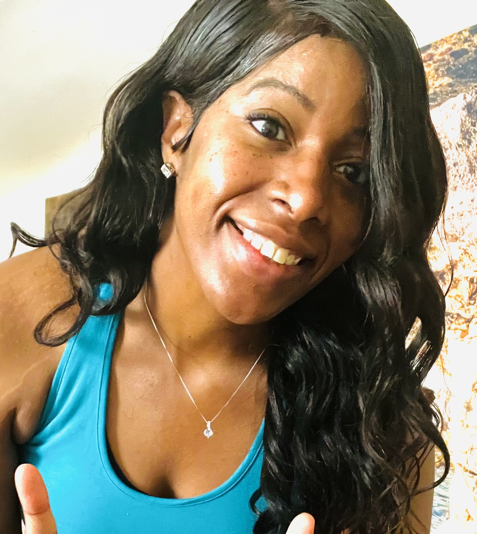Ursula smiling in turquoise activewear, sharing her personal wellness philosophy